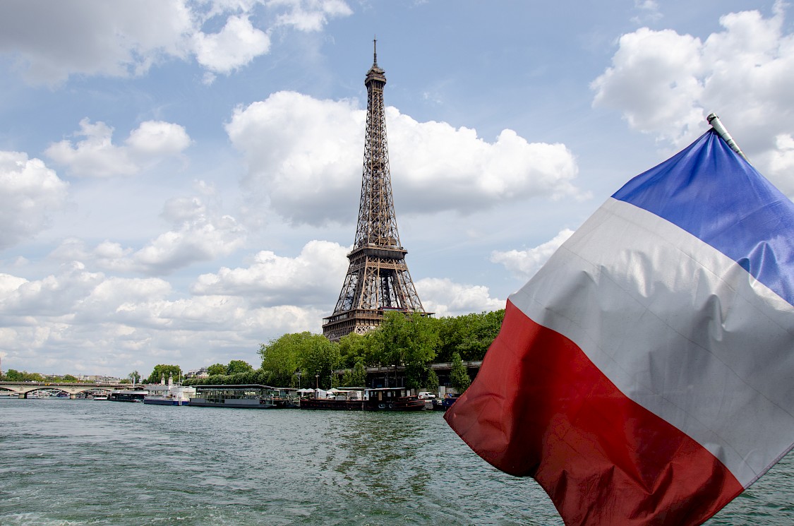 Eiffel Tower in Paris, France, with a French flag
