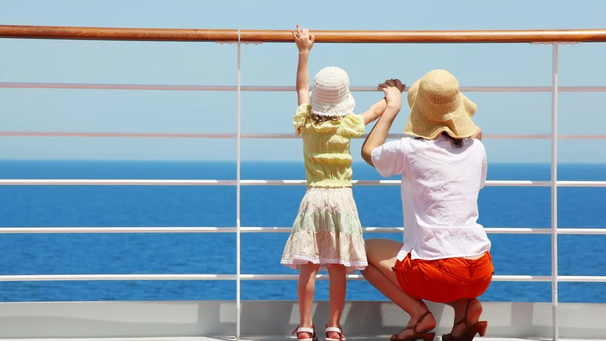 Mother and child looking out to sea from a cruise ship.