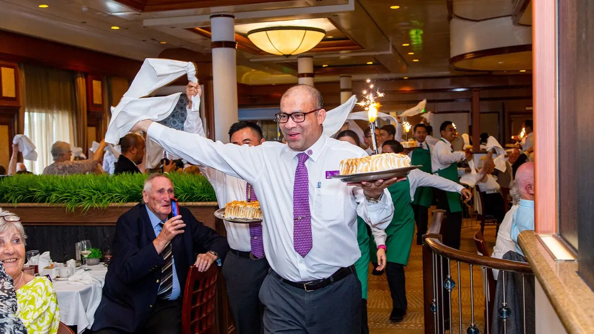 Baked Alaska parade in Buckingham Restaurant onboard Ambience Cruise Ship