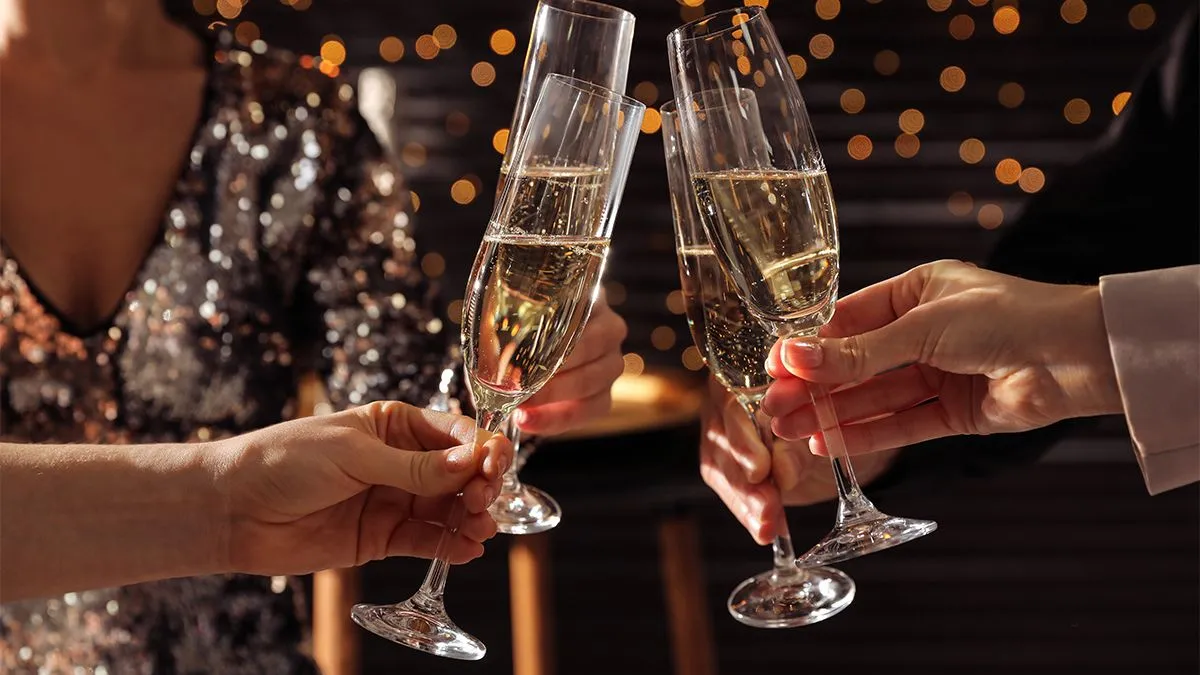People clinking champagne glasses at Christmas