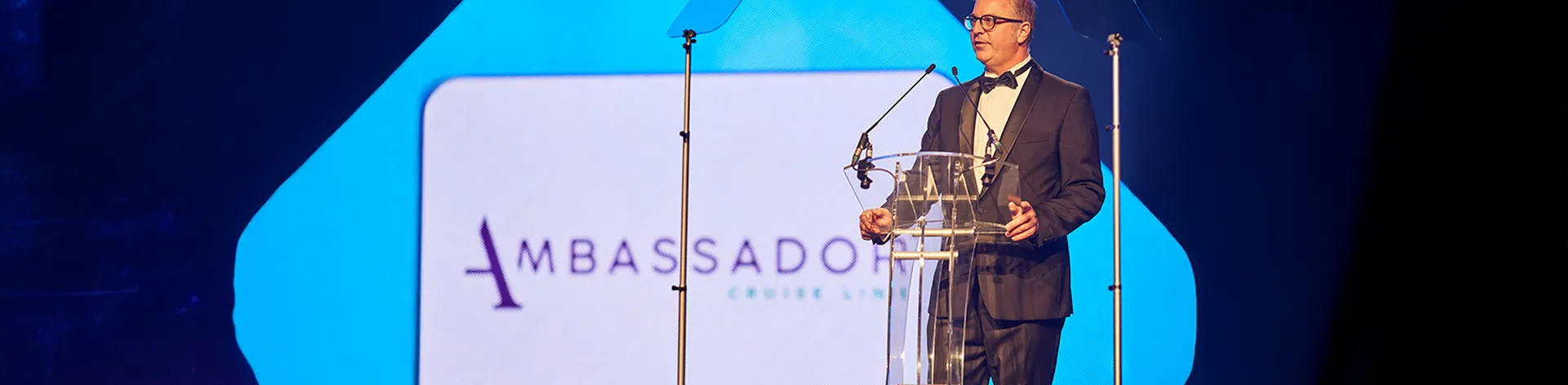 Christian on stage delivering a speech