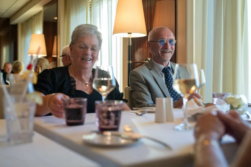Elderly couple enjoying drinks at a restaurant