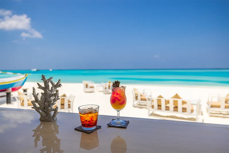 Couple glasses of chilled cocktails with rum on a Caribbean Beach